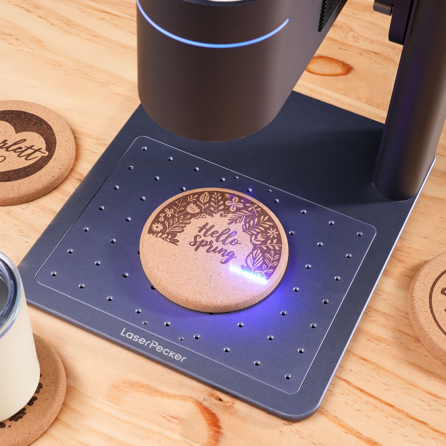 LP4 engraves on a cork coaster with blue laser.