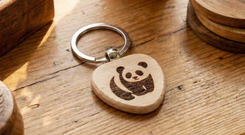 A custom DIY wooden keychain being
engraved with the LP1 Plus, featuring blank wood tags for personalized branding.