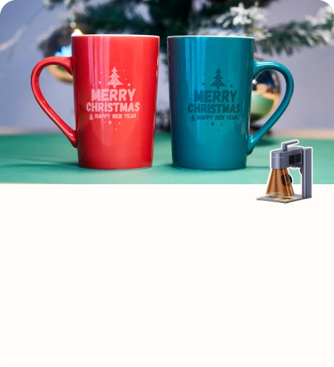 Two personalized mugs engraved with Christmas greetings.