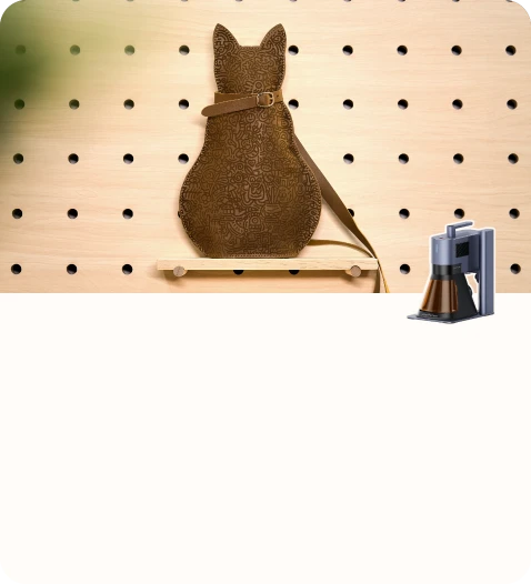 Handmade leather storage pouch designed in the shape of a sitting cat.