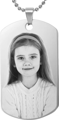 A personalized metal pendant engraved with a portrait of a young girl.