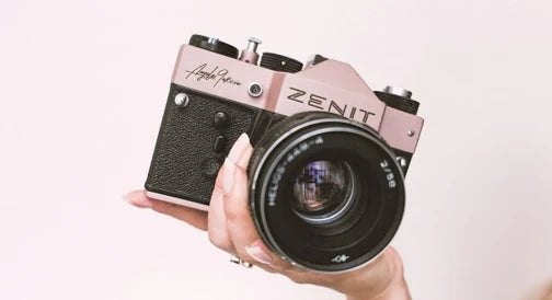A vintage-style camera with an engraved signature.