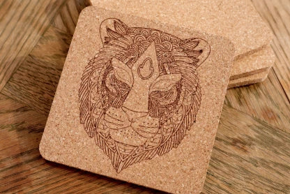 LaserPecker LP2 Plus high-precision laser engraving on a square cork coaster, featuring an intricate tiger head design with sharp, delicate lines.