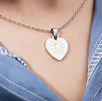 A custom engraved necklace pendant laser etched on-the-spot by LaserPecker LP4 at a craft fair.