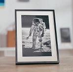 Intricate space theme anodized aluminum desktop plaque featuring a floating astronaut and planets.