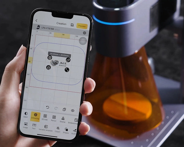 A user easily controlling LaserPecker LP4 via the LDS app on a smartphone for smart laser engraving.