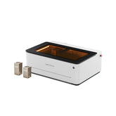 LaserPecker LX2 dual-laser features a fully-enclosed design with openable top and front covers for easy material access. It can  simultaneously support 40W and 20W laser modules for versatile engraving and cutting tasks.