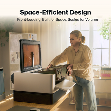 LaserPecker enclosed laser engraver demonstrating its space-efficient, front-loading design. A user loads a workpiece into the machine on a compact workspace, highlighting how the front-access design optimizes tabletop space while maintaining high-volume production capability.
