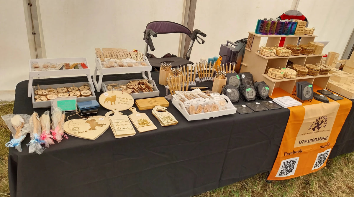A table displaying a variety of wooden engraved products.