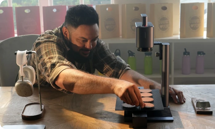 A creator using the LaserPecker LP2 Plus to "Mark Your Business with Precision," creating professional office nameplates and branding materials.