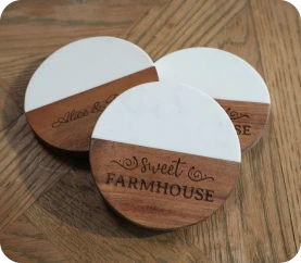 LaserPecker LP2 Plus high-precision engraving on circular wooden coasters, showcasing sharp script fonts and uniform "Sweet Farmhouse" branding on solid wood.