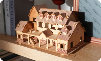 A highly detailed 3D wooden house model assembled from precision-cut pieces, showcasing the high-resolution architectural modeling capabilities of the LP2 Plus.