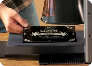 Laser engraving a professional black acrylic wedding sign with elegant script using the LaserPecker LP2 Plus extension setup.