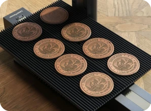 LaserPecker LP2 Plus with Slide Extension accessory, performing high-speed batch engraving on a series of circular leather coasters with consistent precision.