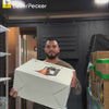 Man engraving brand logos on objects with the LaserPecker LP4.